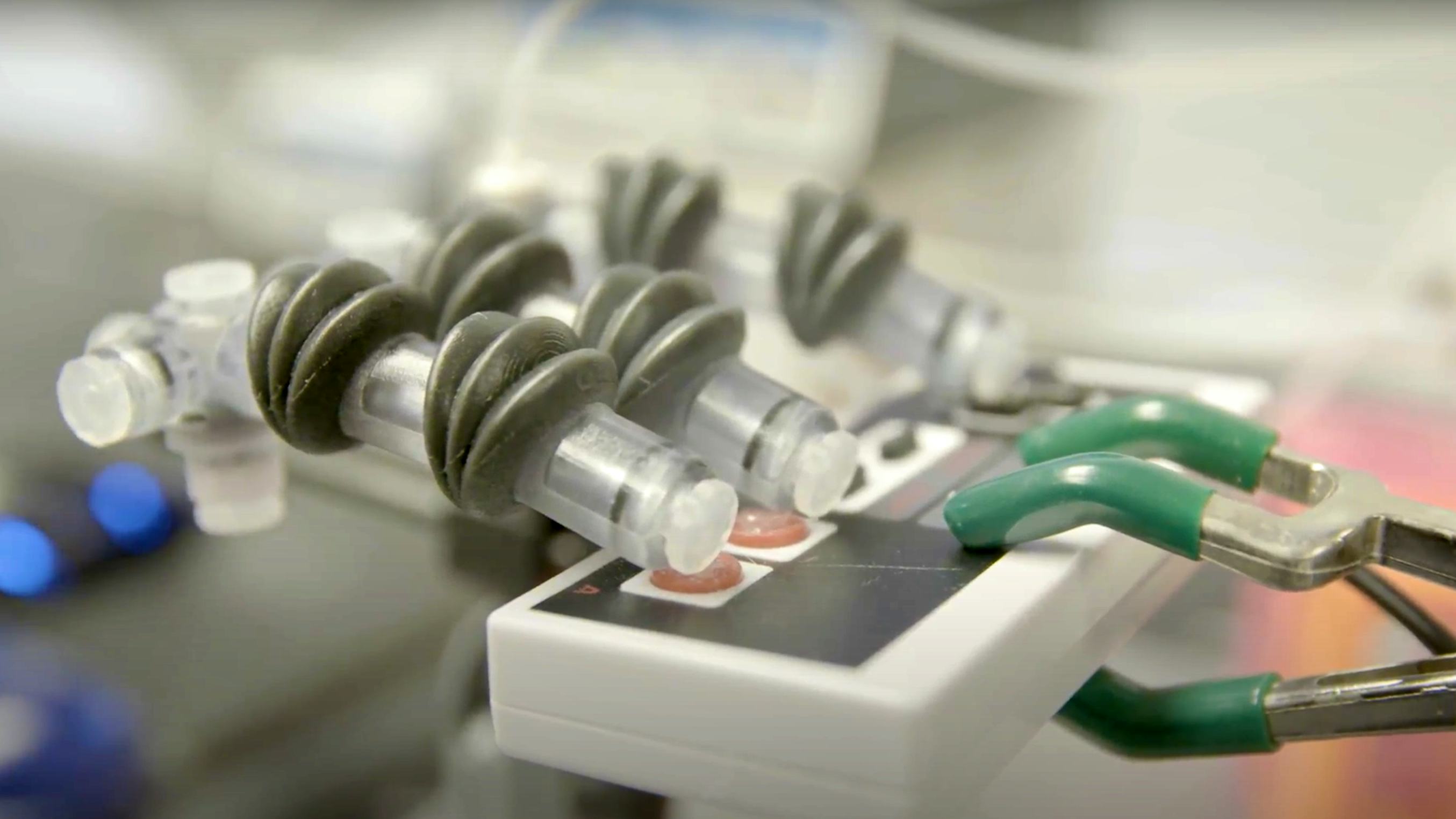 A photo of a 3D printed robotic hand on an old gaming controller.