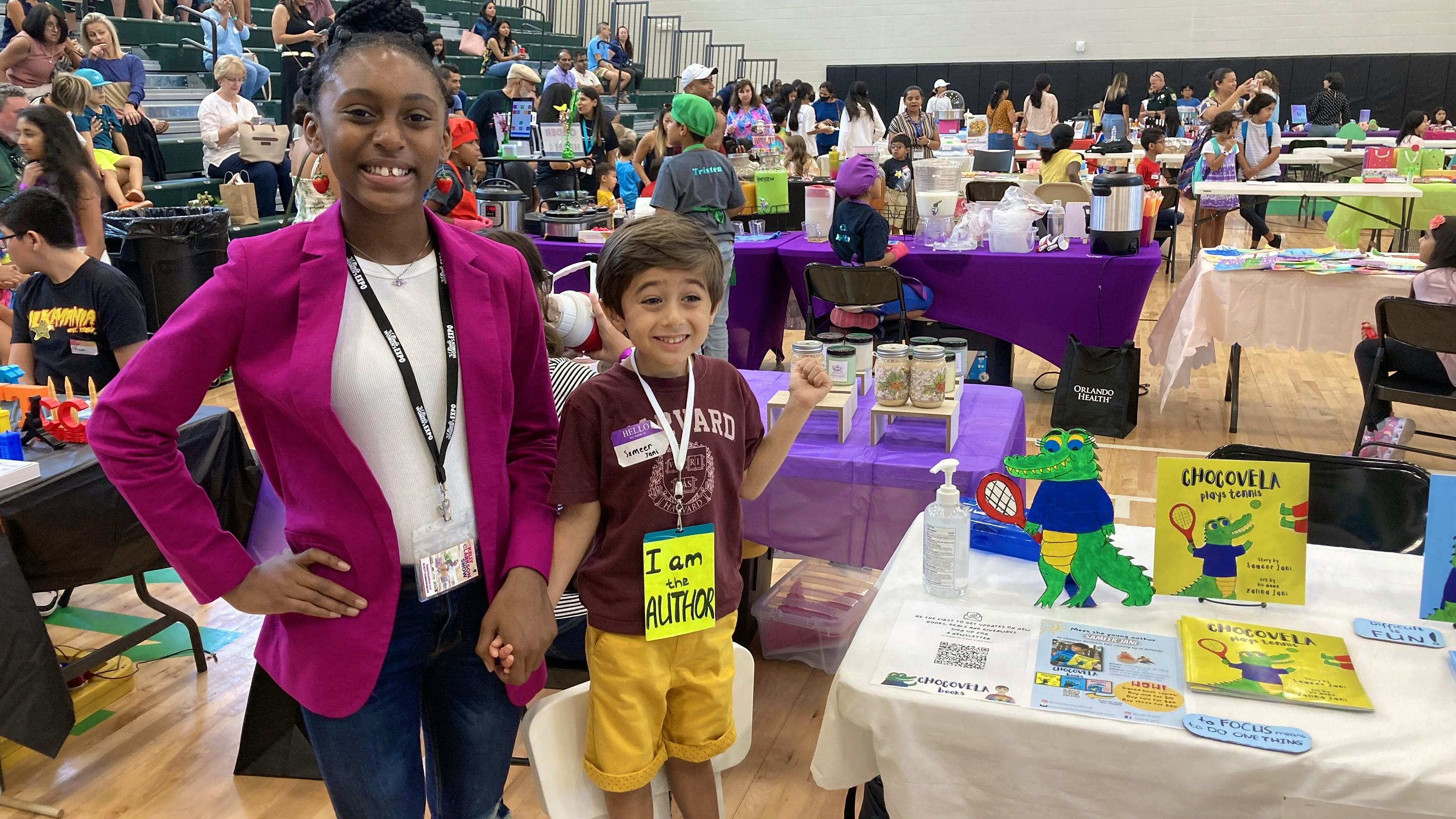 Two kids at a business fair. 