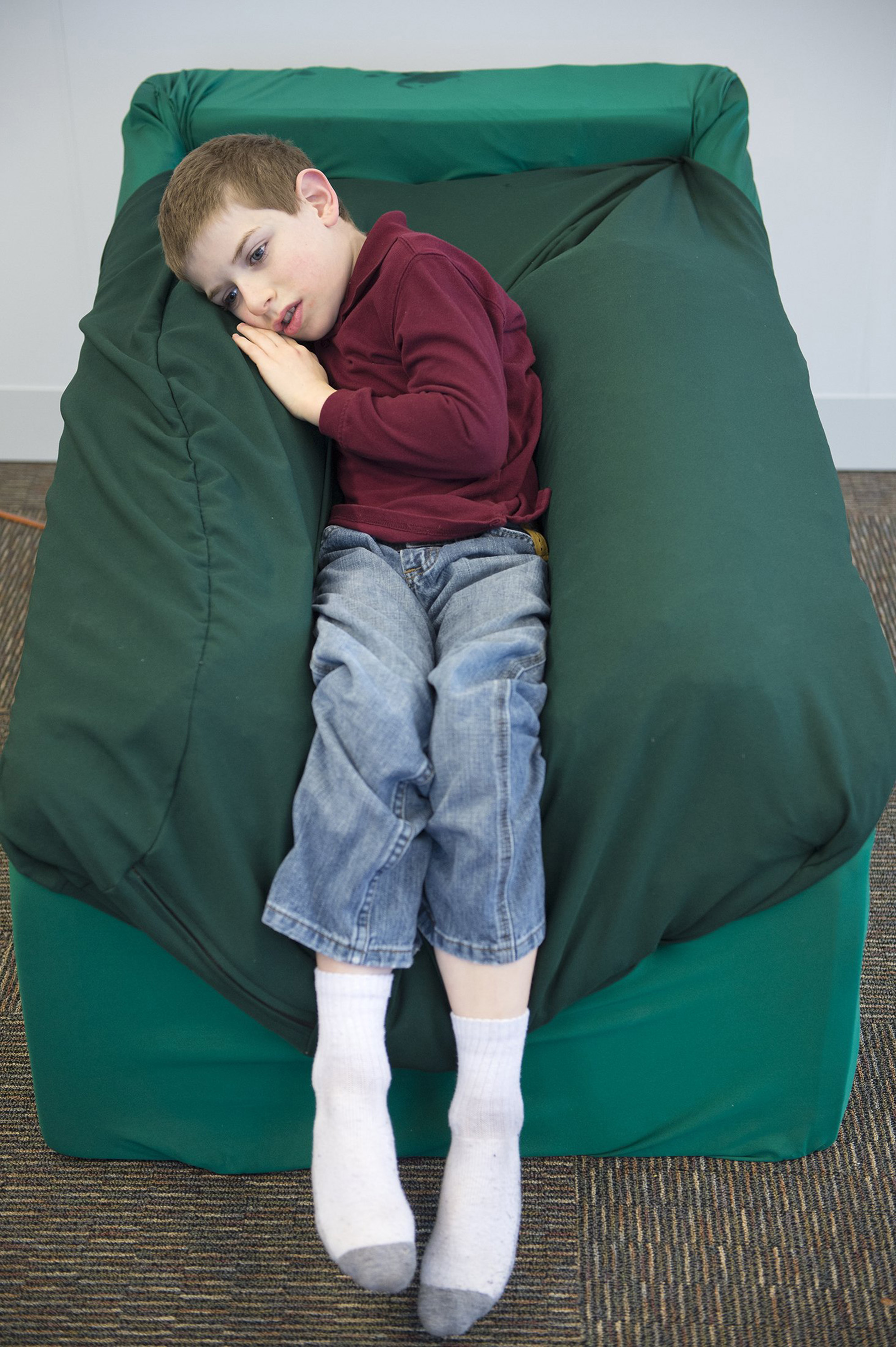 Newsela Kids with autism relax in hug chair made by high school students
