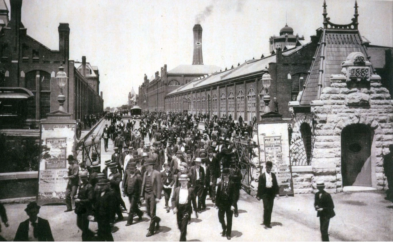 A group of people walking in front of a building.